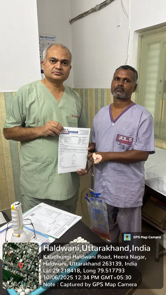 Dr. Adarsh Kumar handing over medical report to patient